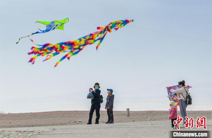 圖為孩童在父母的陪伴下放風(fēng)箏?！⊥醣筱y 攝