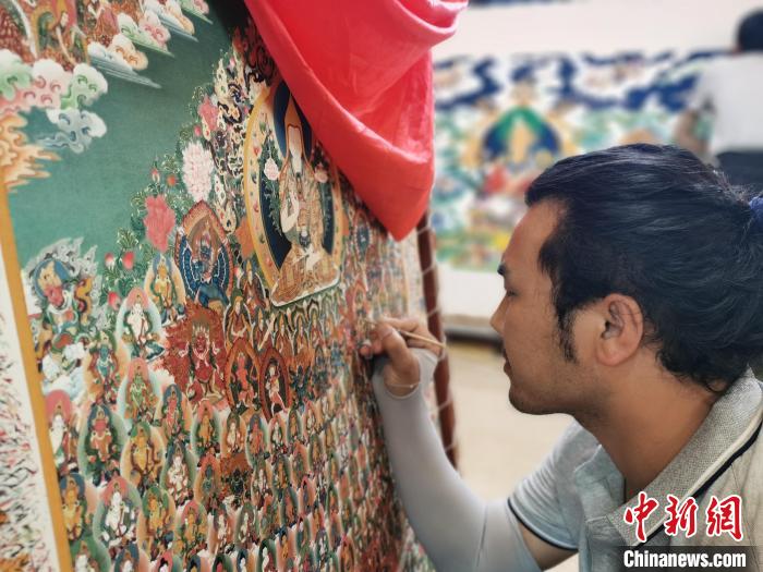 圖為更登才讓的徒弟繪畫唐卡。　張?zhí)砀?攝